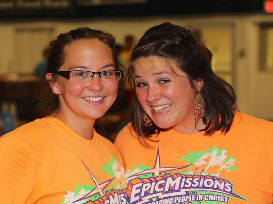 Two girls smiling with  Epic Mission T-shirts on