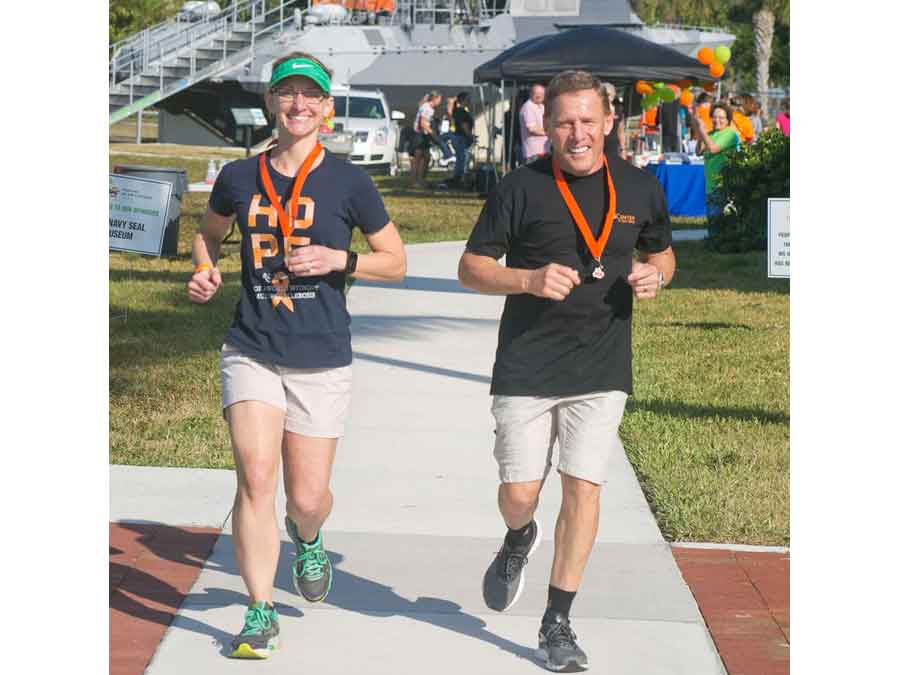 Two of the walkers jogging across the finish line