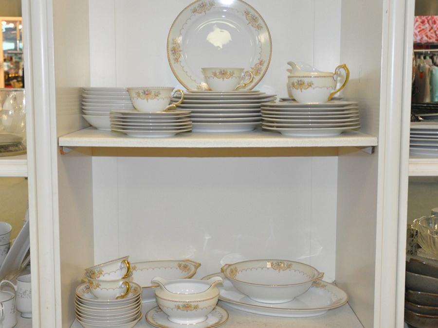 Dishes and cups on shelves for sale