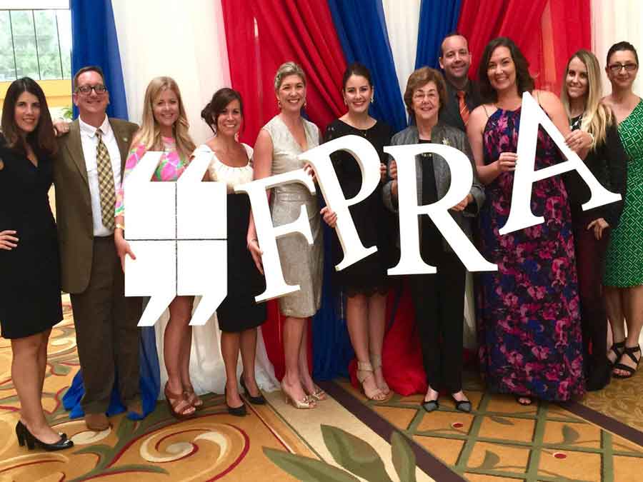 Florida Public Relations Association group photo holding up letters of logo