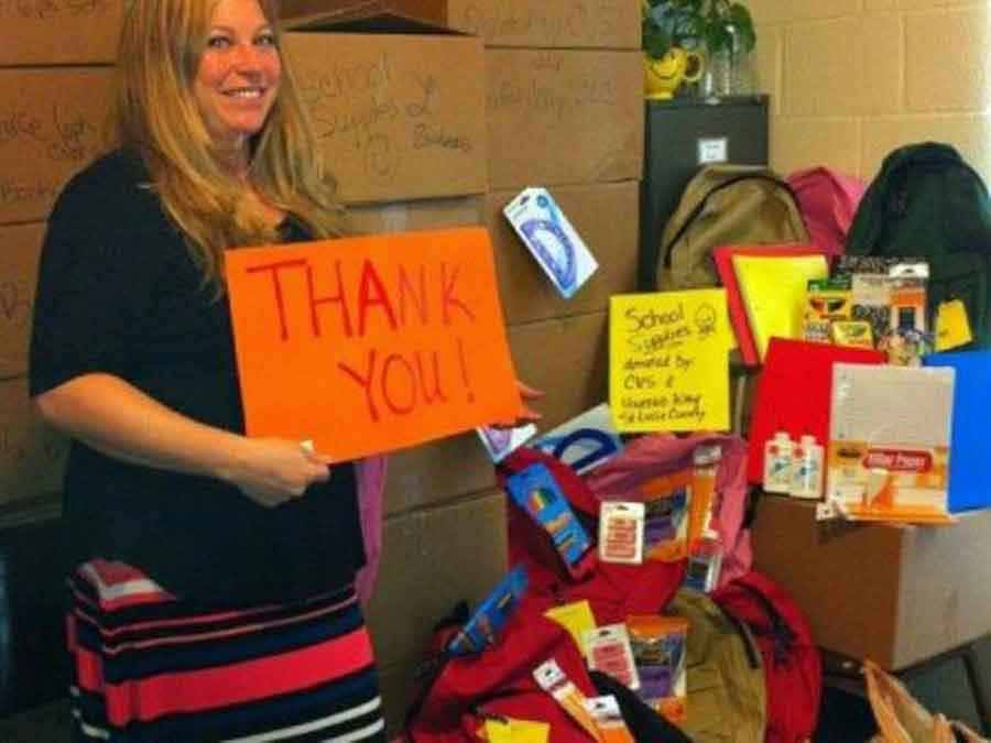 HoGirl holding a 'Thank you' sign in front of donations