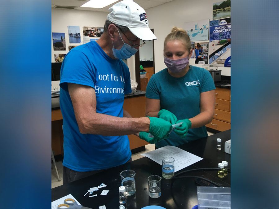 A man and a woman testing water samples at Citizen Science center in Vero Beach