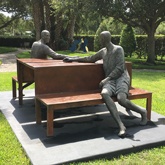 Sculpture of man and woman holding hands while sitting across from each other at a picnic tableat Vero Beach Museum of Art Vero Beach Florida