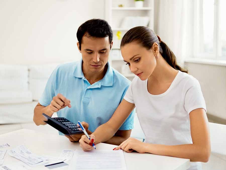 Couple working on finances with calculator